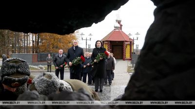 Kochanova lays flowers at memorial to war victims