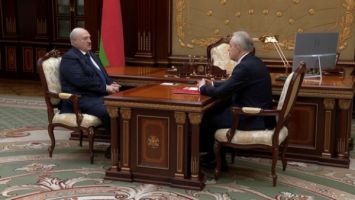 Lukashenko hears out a report from the head of the Belarus President Administration
